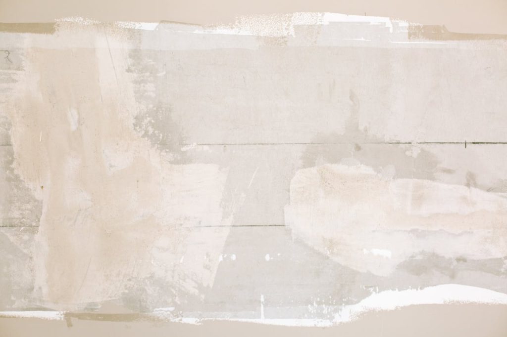 unfinished-painted-wall-3616762 Close-up of an unfinished wall showing plaster and paint textures in a home renovation.